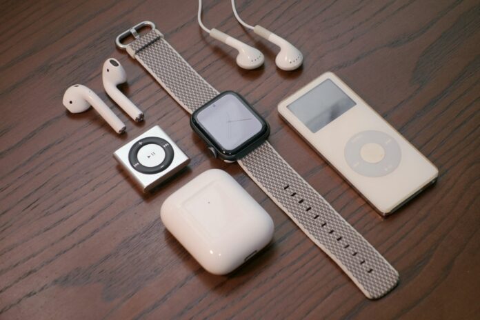 Photo by Cartoons Plural white apple earpods beside white ipod nano