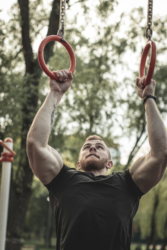 Photo by Мария Волк man in black crew neck t-shirt holding red plastic ring