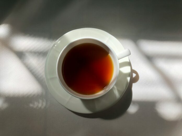 Photo by panchanok prem a cup of tea sitting on top of a table