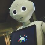 AI가 이끄는 건강 관리, 내 일상은 어떻게 달라질까? white robot toy holding black tablet